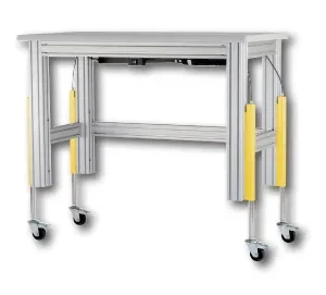 Dyna-Lift External Extrusion Mount System - Sistema de elevación externo para perfiles de aluminio con ruedas Dyna-Lift External Extrusion Mount System montado externamente en una estructura de perfil de aluminio con ruedas pivotantes para estaciones de trabajo móviles.